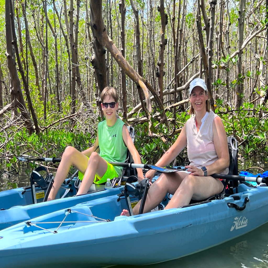 Mother and son on private kayak tour, mangrove tunnel. Hobie Kayak